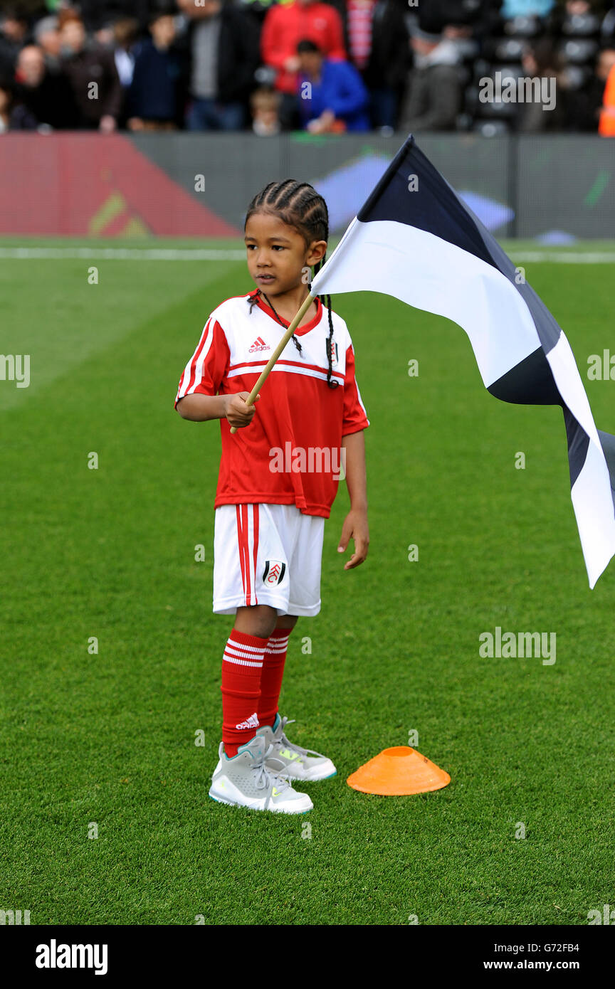A fulham flag bearer greets the two teams hires stock photography and