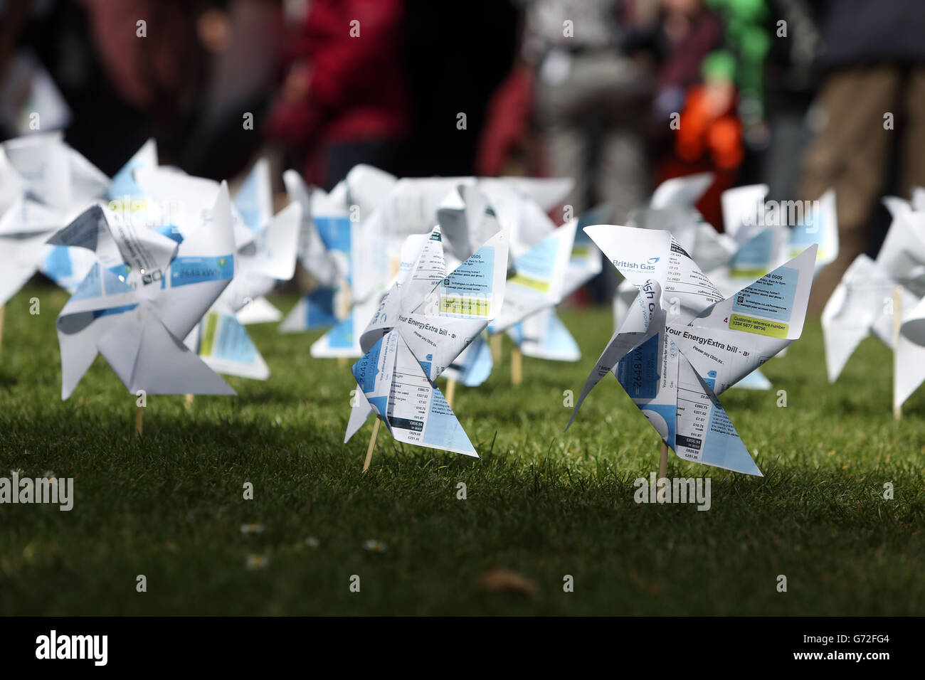 Windmills made from British Gas bills placed by protesters outside the Queen Elizabeth II Conference Centre in central London, during the Centrica AGM. Stock Photo