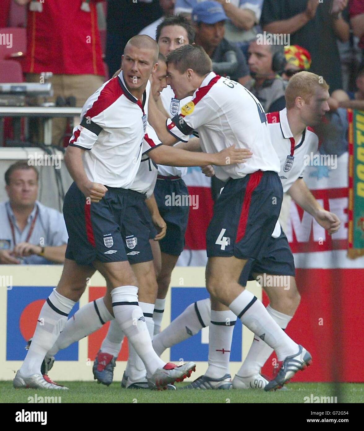 England's Michael Owen (2nd L) celebrates scoring against Portugal with team-mates Steven Gerrard (R) and David Beckham (L) during the Euro 2004 quarter-final match at the Estadio de Luz, Lisbon, Portugal. Stock Photo