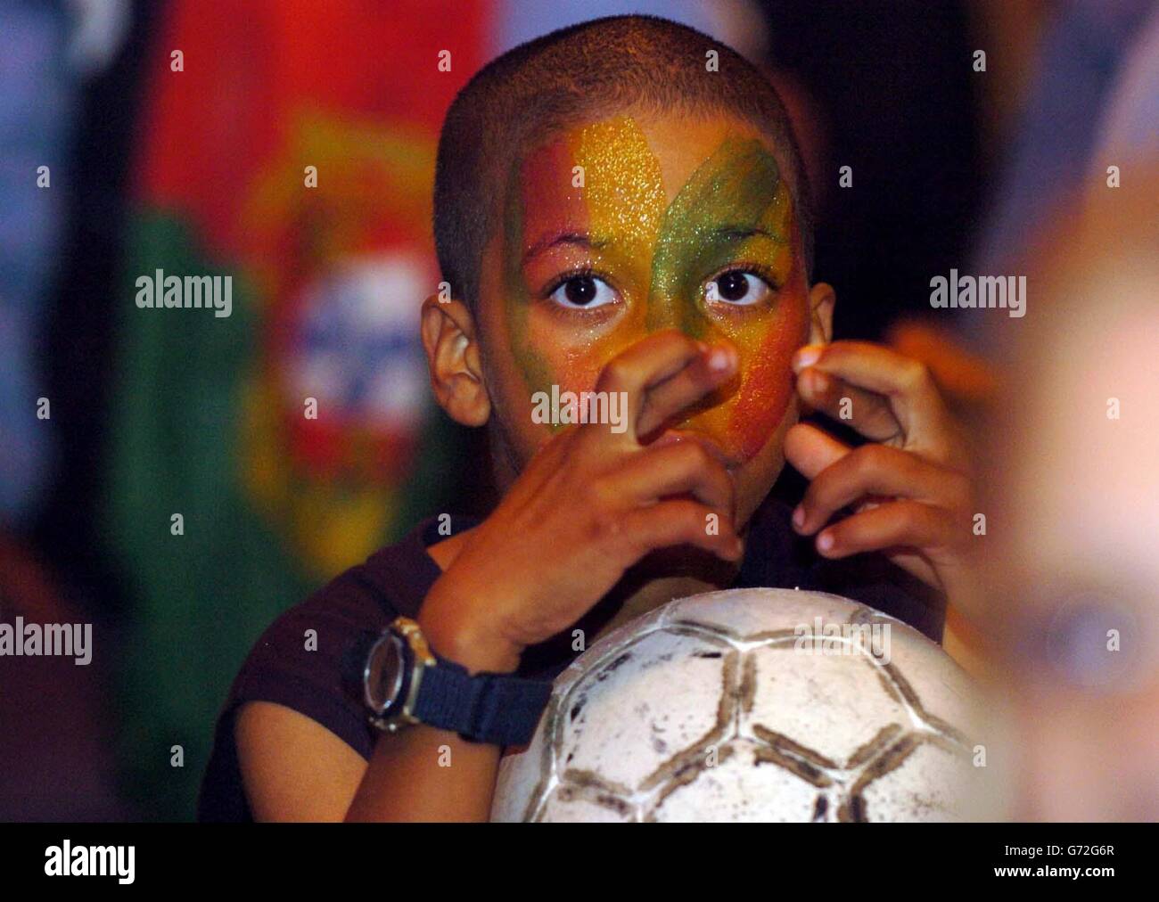 Tjago Pascoal, 10, cheers on Portugal at the Red Lion pub in Thetford, Norfolk, as England take on his team in the Euro 2004 quarter finals in Portugal. Stock Photo