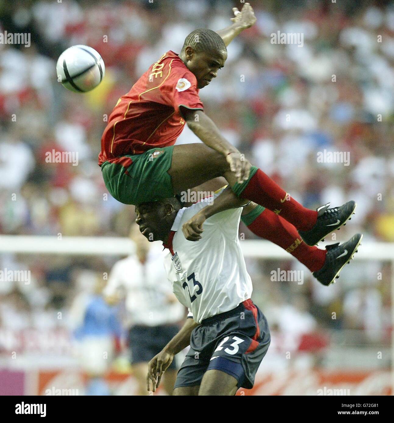 England's Darius Vassell (bottom) battles with Portugal's Jorge Andrade for the ball during the Euro 2004 quarter-final match at the Estadio de Luz, Lisbon, Portugal. Stock Photo