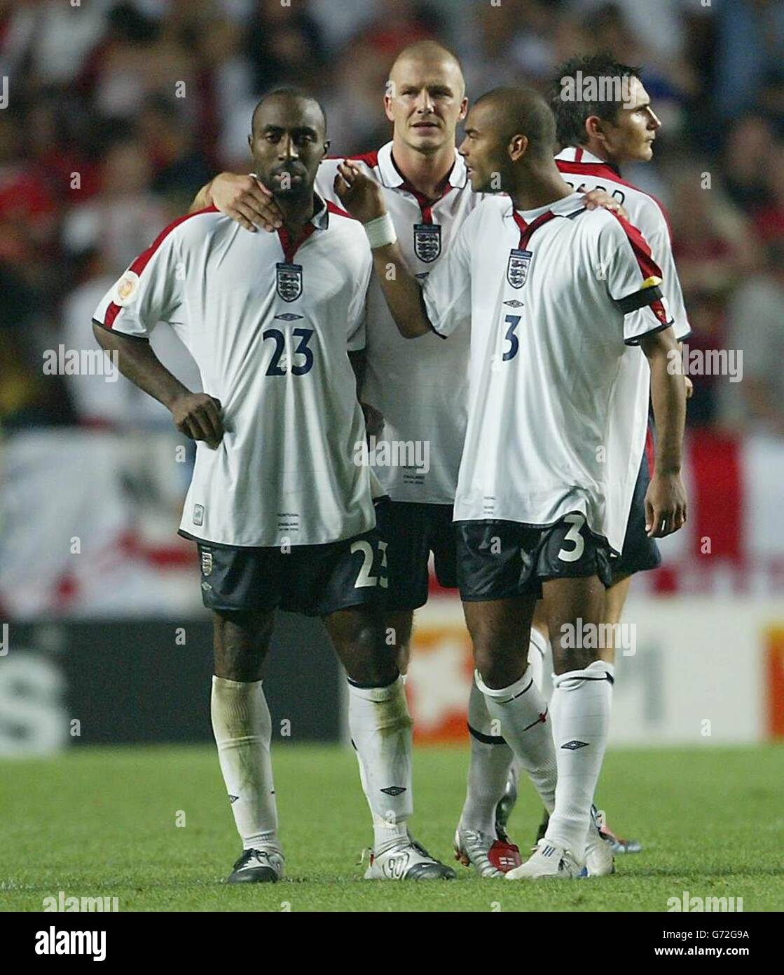 England's Darius Vassell (L) is consoled by team-mates David Beckham and Ashley Cole (R) after missing a penalty against Portugal during the Euro 2004 quarter-final match at the Estadio da Luz, Lisbon, Portugal. England lost to Portugal 6-5 on penalties after the match ended in a 2-2 draw following extra-time. EDITORIAL USE ONLY, NO MOBILE PHONE OR PDA USE. INTERNET USE ONLY ON UEFA AUTHORISED SITES AND THEN, NO MORE THAN 10 PHOTOGRAPHS PER HALF OF NORMAL PLAYING TIME AND FIVE PHOTOGRAPHS PER HALF OF EXTRA TIME CAN BE PUBLISHED VIA THE INTERNET WITH AN INTERVAL OF AT LEAST ONE MINUTE BETWEEN Stock Photo