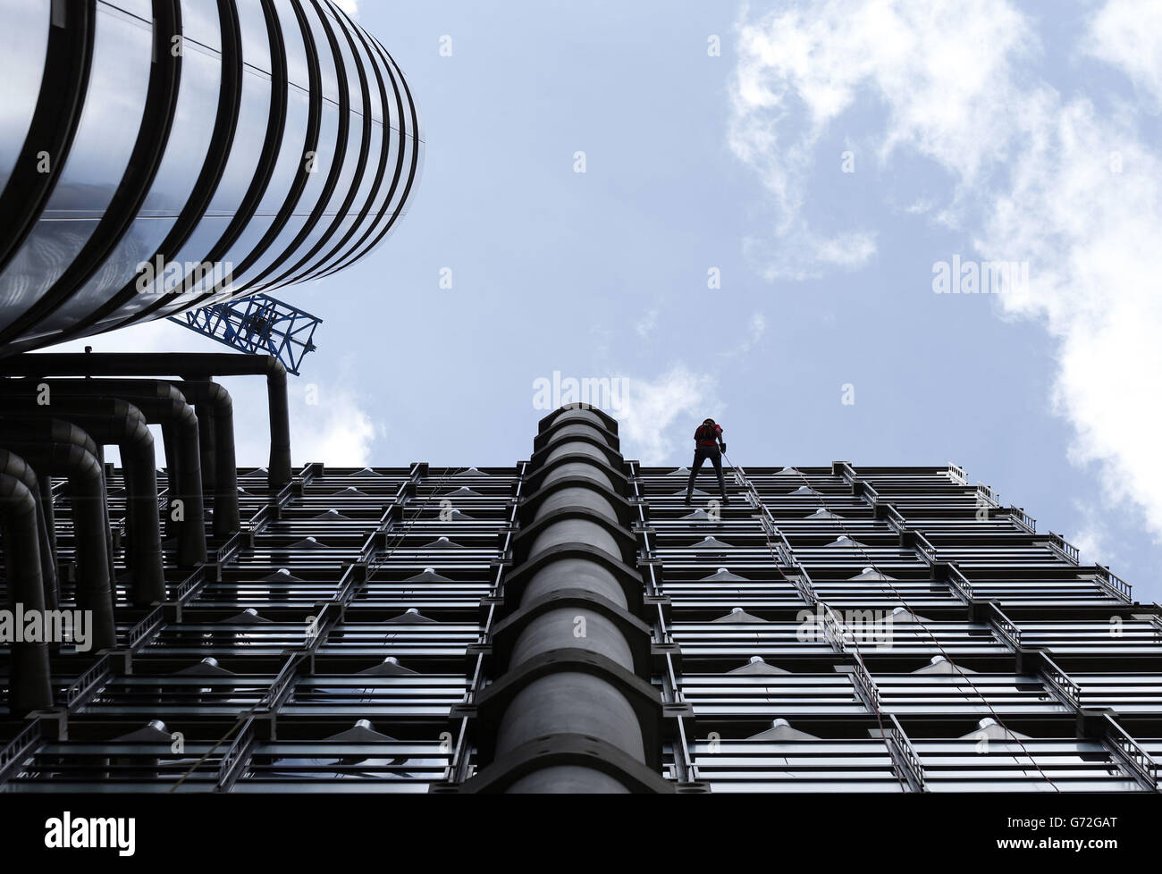Fundraisers employed in the City of London abseil down the Lloyds of London building in aid of the charity RedR UK. Stock Photo