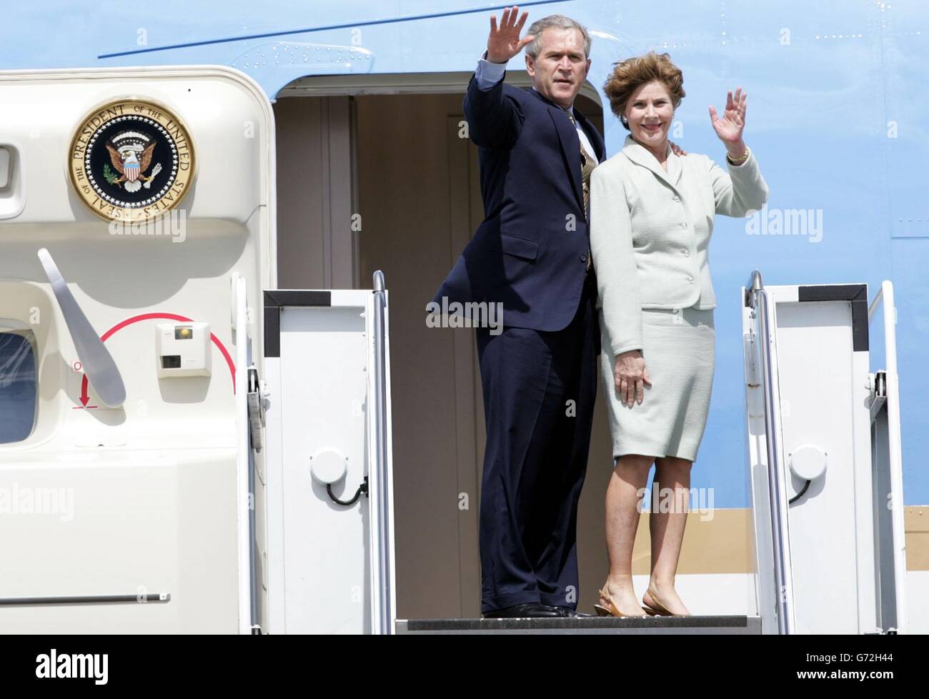 US President, George W. Bush, waves to media with First Lady, Laura Bush before boarding Airforce One at Shannon Airport, before flying on to his next engagement in Turkey. Stock Photo