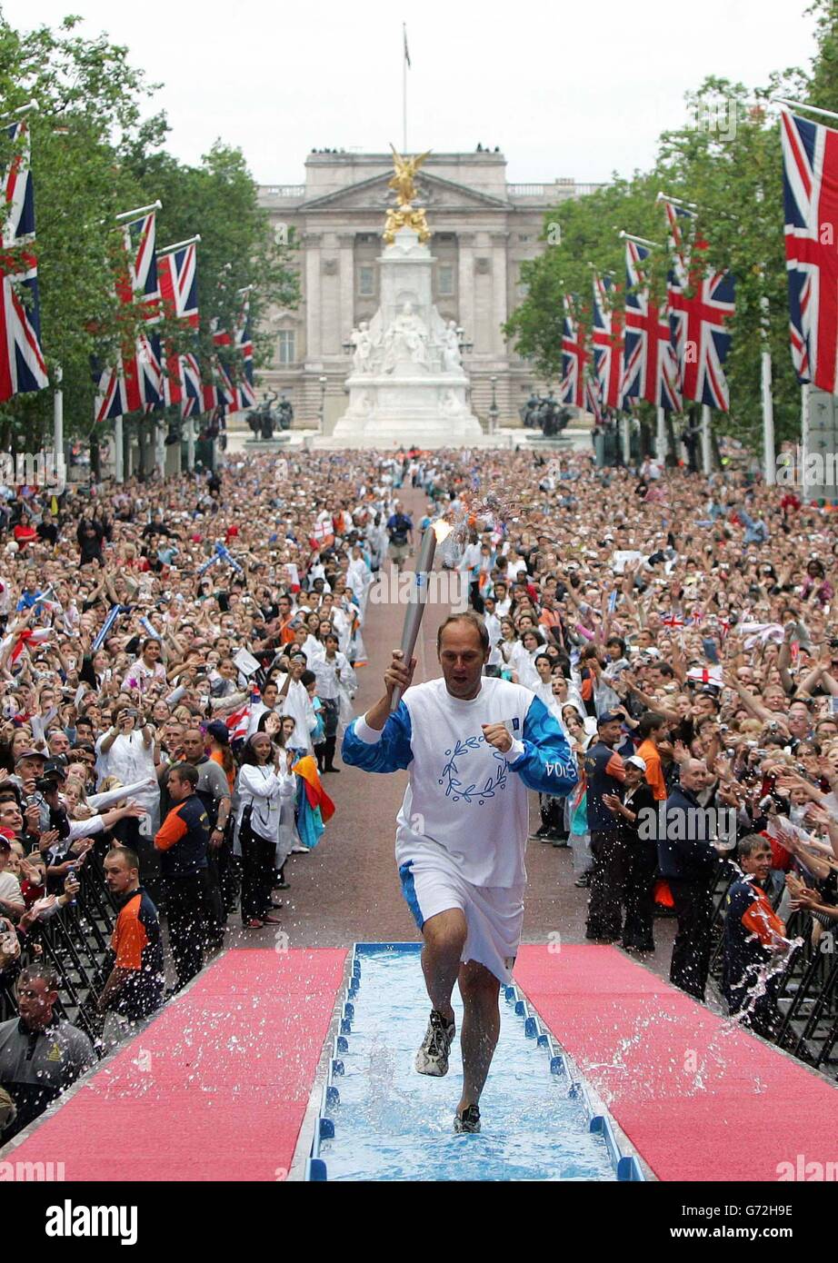 Sir Steve Redgrave arrives on stage to light the Olympic Cauldron on The Mall, London, where the Olympic Torch Relay finished the journey through the capital after starting from the All England Lawn Tennis Club in Wimbledon. Stock Photo