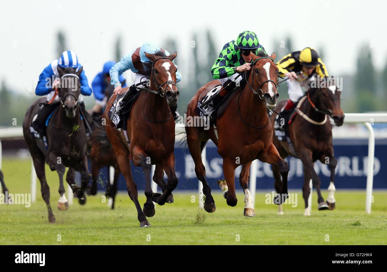Volume ridden by Richard Hughes (right) on their way to victory in the Swettenham Stud Fillies&acute; Trial Stakes during the Starlight Charity Raceday at Newbury Racecourse, Berkshire. Stock Photo