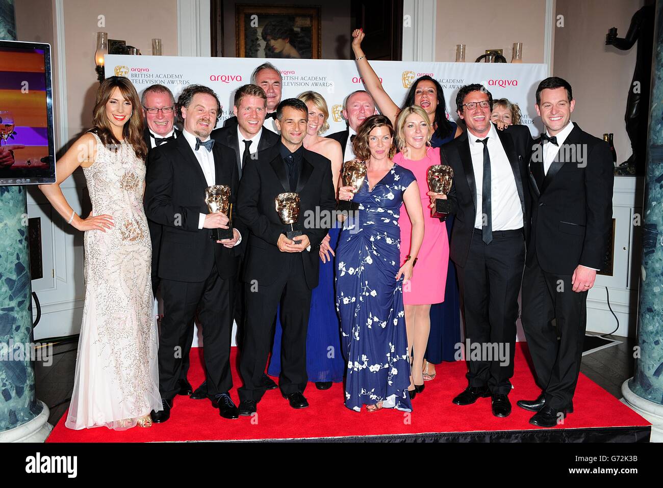 Production crew of Bedlam with the Factual Series Award for Bedlam, alongside presenters Matt Baker (far rigth) and Alex Jones (far left) at the Arqiva British Academy Television Awards 2014 at the Theatre Royal, Drury Lane, London. Stock Photo