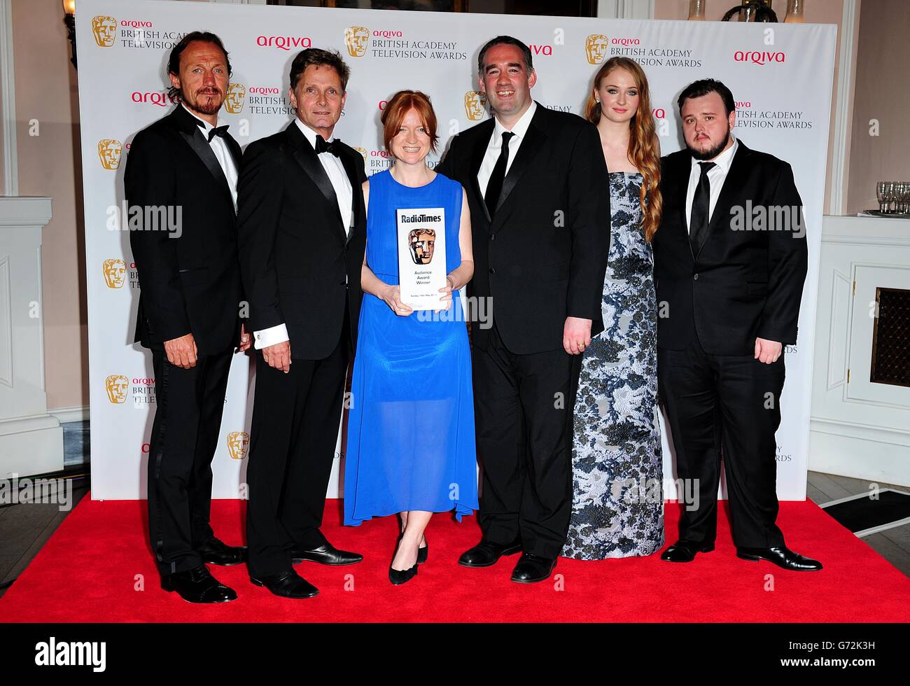 Presenters Jerome Flynn (far left), Sophie Turner (second rigth) and John Bradley (far right) with winners of the Audience Award for Doctor Who, at the Arqiva British Academy Television Awards 2014 at the Theatre Royal, Drury Lane, London. Stock Photo