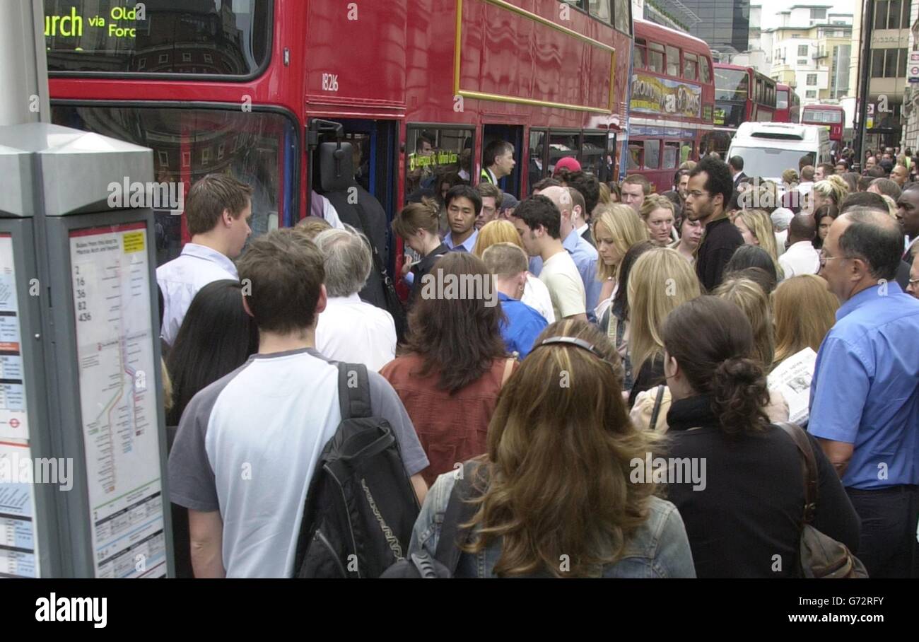 Passengers queue for buses outside Victoria Station, as a 24 hour strike by thousands of workers on London Underground brought travel chaos to the capital. Many Tube lines were at a complete standstill in the normally bustling morning rush-hour, forcing thousands of people to drive or even walk to work. Stock Photo