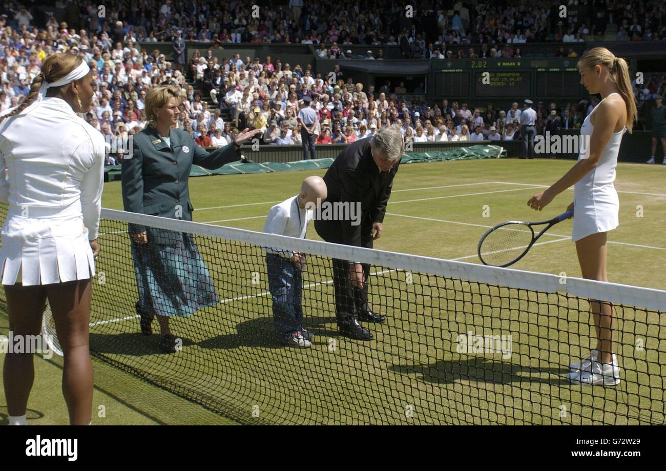 Five year old Emily Bailes from Walsall in the West Midlands performs the coin toss to decide who will serve first between Serena Williams (left) and Maria Sharapova in the final of the Ladies' Singles tournament at The Lawn Tennis Championships at Wimbledon. Emily was representing the Birmingham Children's Hospital Charity which raises money to purchase equipment for the hospital. She was assisted by the tournament referee Alan Mills and the match umpire Alison Lang. , NO MOBILE PHONE USE. Stock Photo