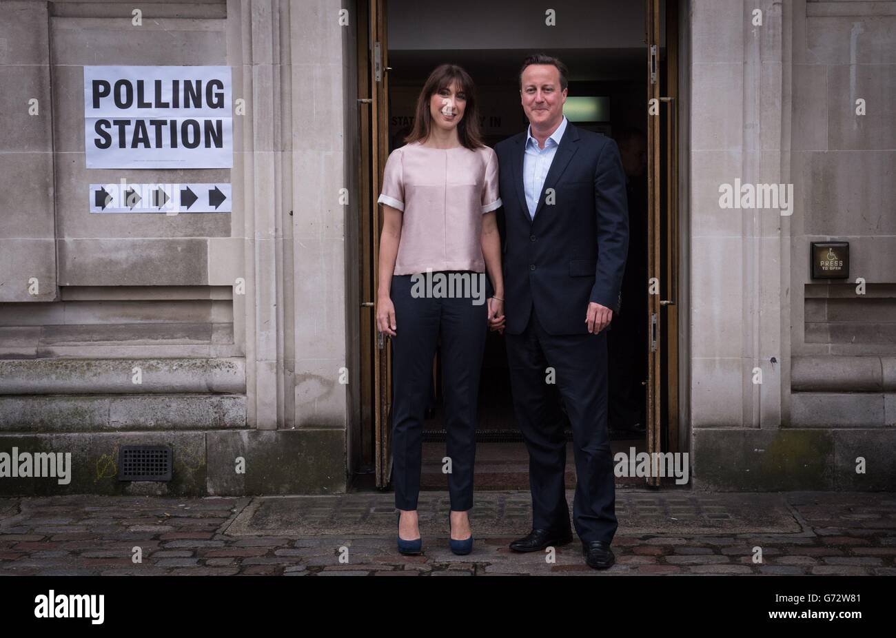 Prime Minister David Cameron and his wife Samantha leave Methodist Central Hall in Westminster after voting. Polling has opened across Britain as millions of voters cast their ballots in European and local council elections. Stock Photo