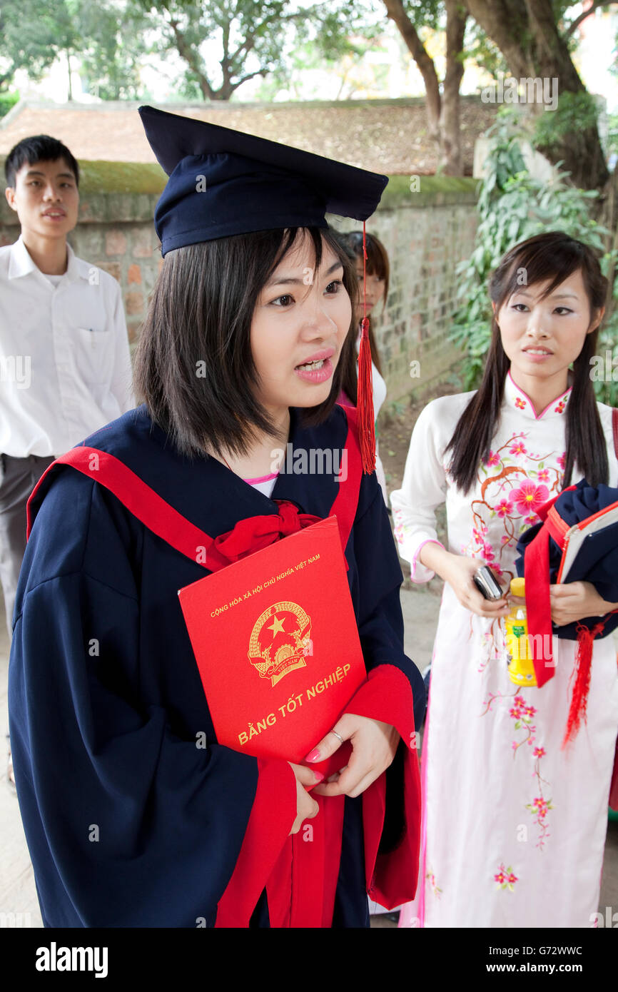 young graduates Vietnamese student standing in front of university building on graduation day in Hanoi, Vietnam Stock Photo
