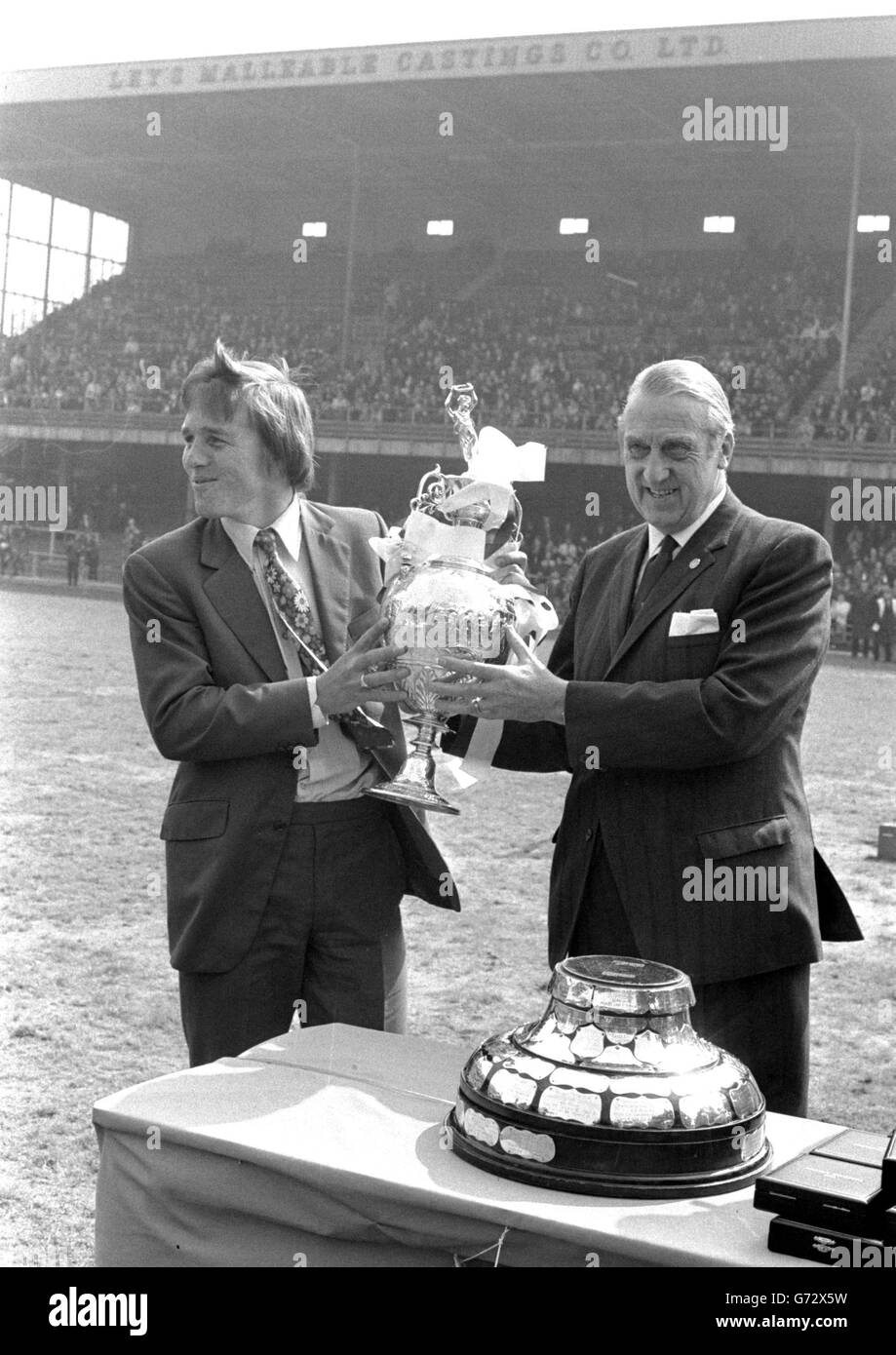 About 15,000 supporters enjoyed the free spectacle of the presentation to Derby County of the Football League Championship trophy for the first time in their history. League President, Len Shipman (right) is seen presenting the Cup to Colin Boulton, goalkeeper at the Baseball Ground. Stock Photo