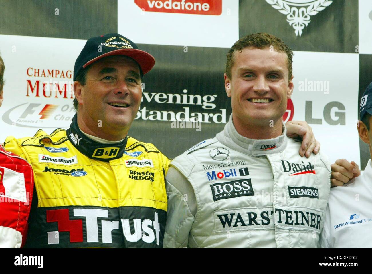 Former F1 World Champion Nigel Mansell and current F1 driver David Coulthard  stand on the podium in London's Regent Street, before a race around a  section of the West End. Competitors from