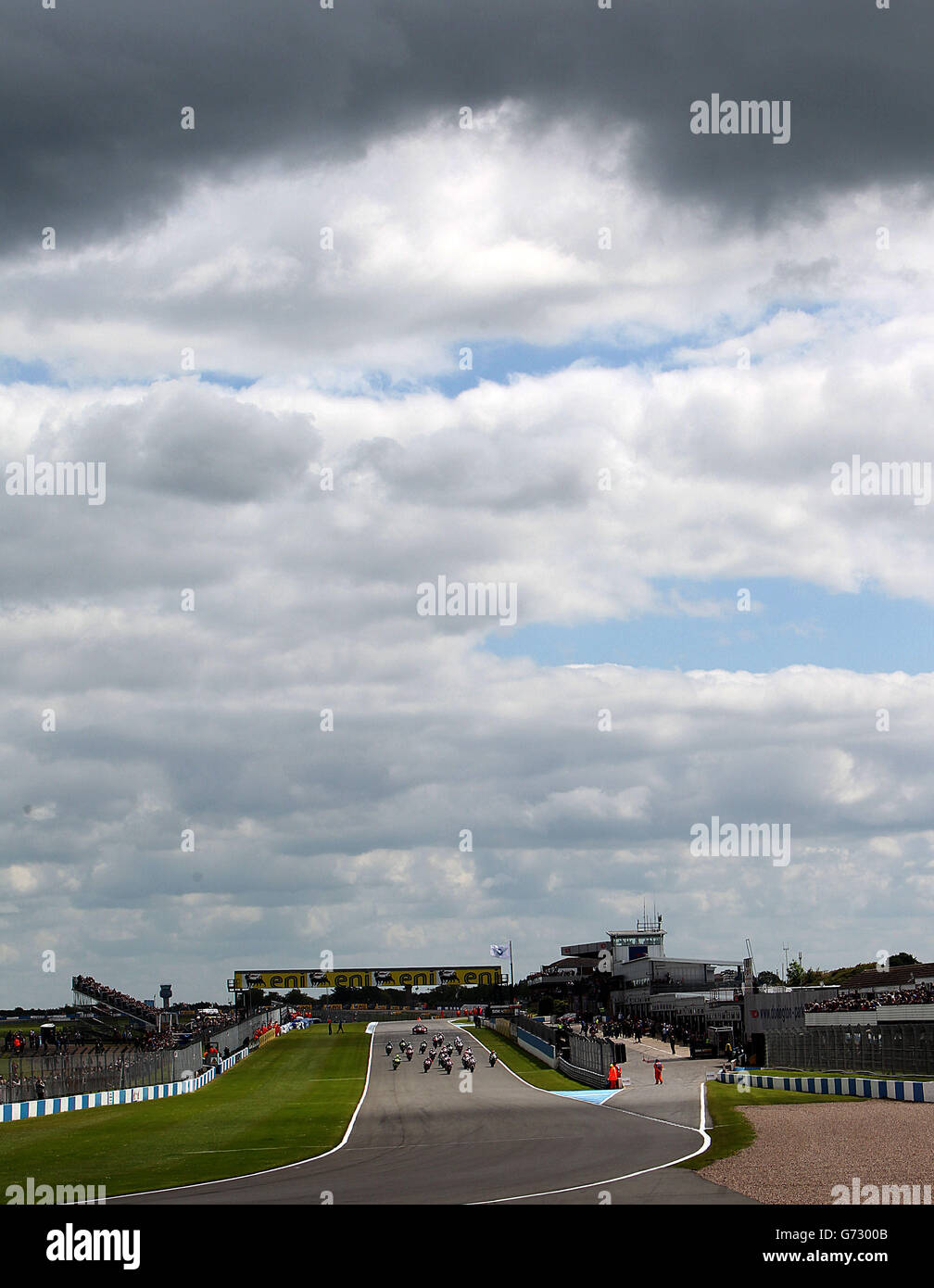 Riders head down towards the first turn during the first race during round 5 of the Superbikes FIM World Championship at Donington Park, Donington. Stock Photo