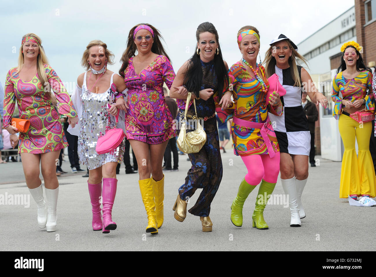 Racegoers in fancy dress have fun during the Sandy Lane Stakes day at Haydock Park Racecourse. Stock Photo