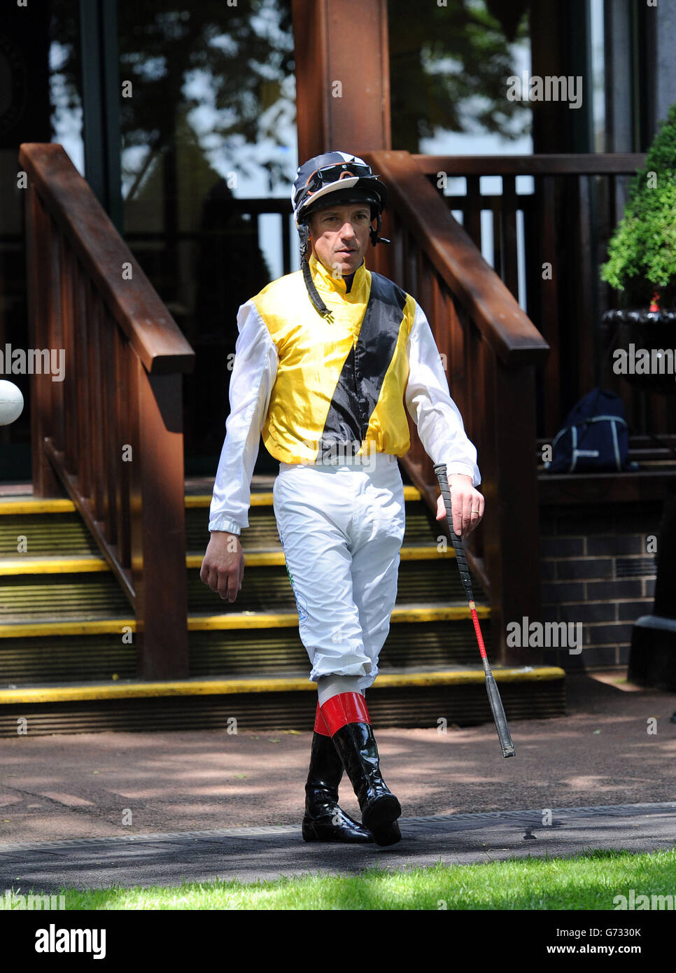 Jockey Frankie Dettori arrives into the parade ring during the Sandy Lane Stakes day at Haydock Park Racecourse. Stock Photo