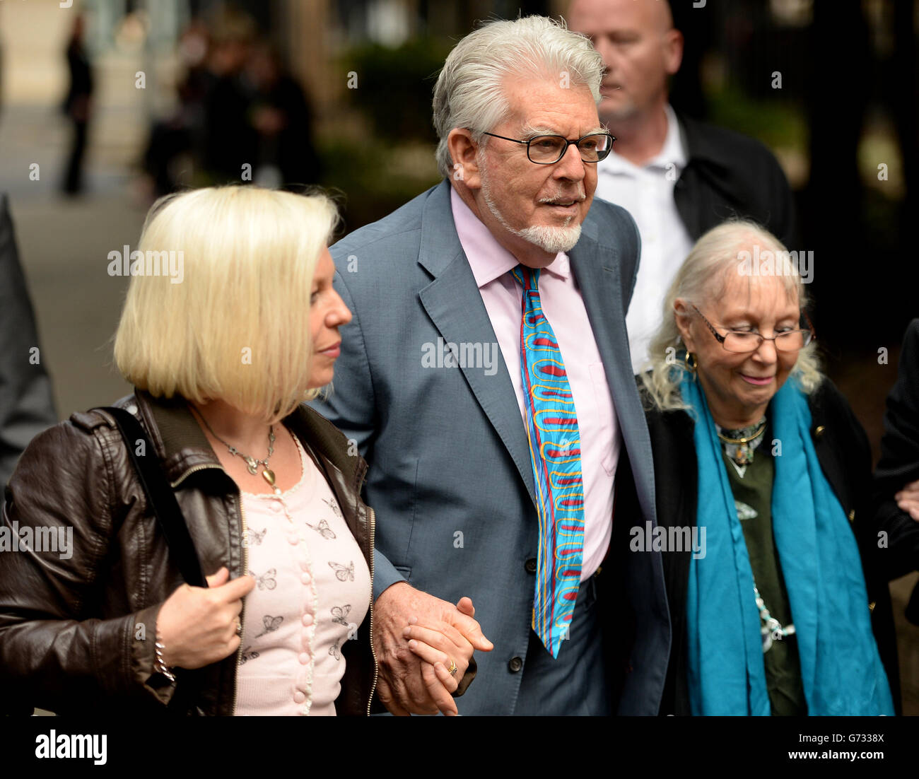 Veteran entertainer Rolf Harris (centre) arrives at Southwark Crown Court, London, with daughter Bindi (left) and wife Alwen, where he denies 12 counts of indecent assault between 1968 and 1986. Stock Photo