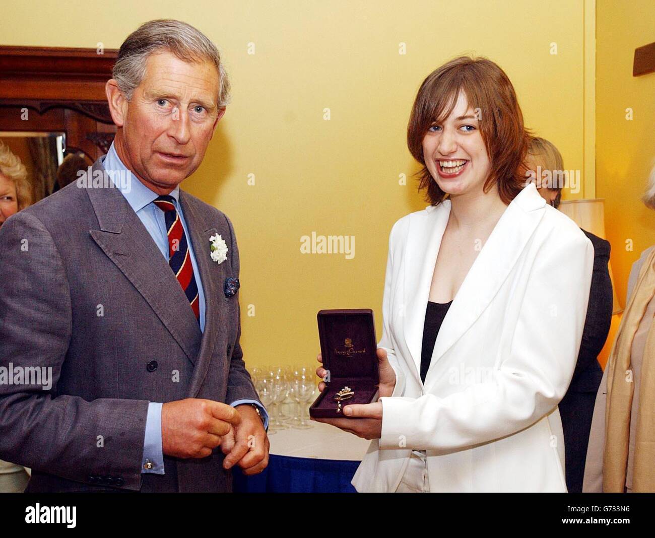 The Prince of Wales stands with his new official harpist Jemima Phillips with her 'Broach of Office' at the Great House Hotel in Laleston. Jemima Phillips, 22, follows award-winning harpist Catrin Finch, 24, who took up the post four years ago when Prince Charles reinstated the ancient royal tradition of having an Official Harpist. Miss Phillips, whose family are from Ebbw Vale in South Wales, is currently living in London, completing a course at the Royal College of Music. Stock Photo