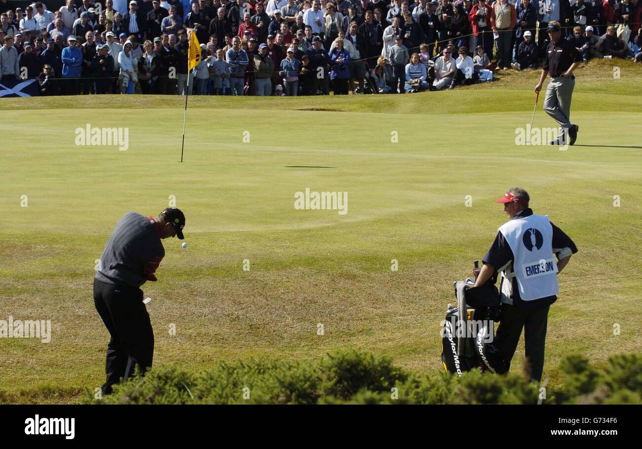 England's Gary Emerson chips from the edge of the 12th green watched by Northern Ireland's Darren Clarke during The 133rd Open Golf Chamionship at the Royal Troon golf course in Scotland Stock Photo
