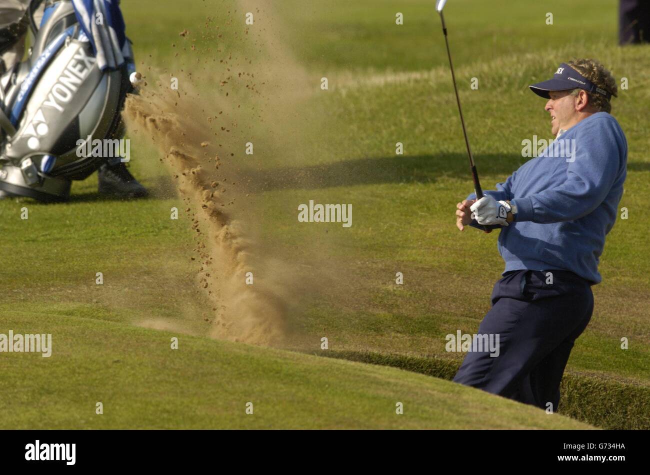 Scotland's Colin Montgomerie falls in the bunker on the 14th hole after playing his shot during The 133rd Open Golf Chamionship at the Royal Troon golf course in Scotland , NO MOBILE PHONE USE. Stock Photo