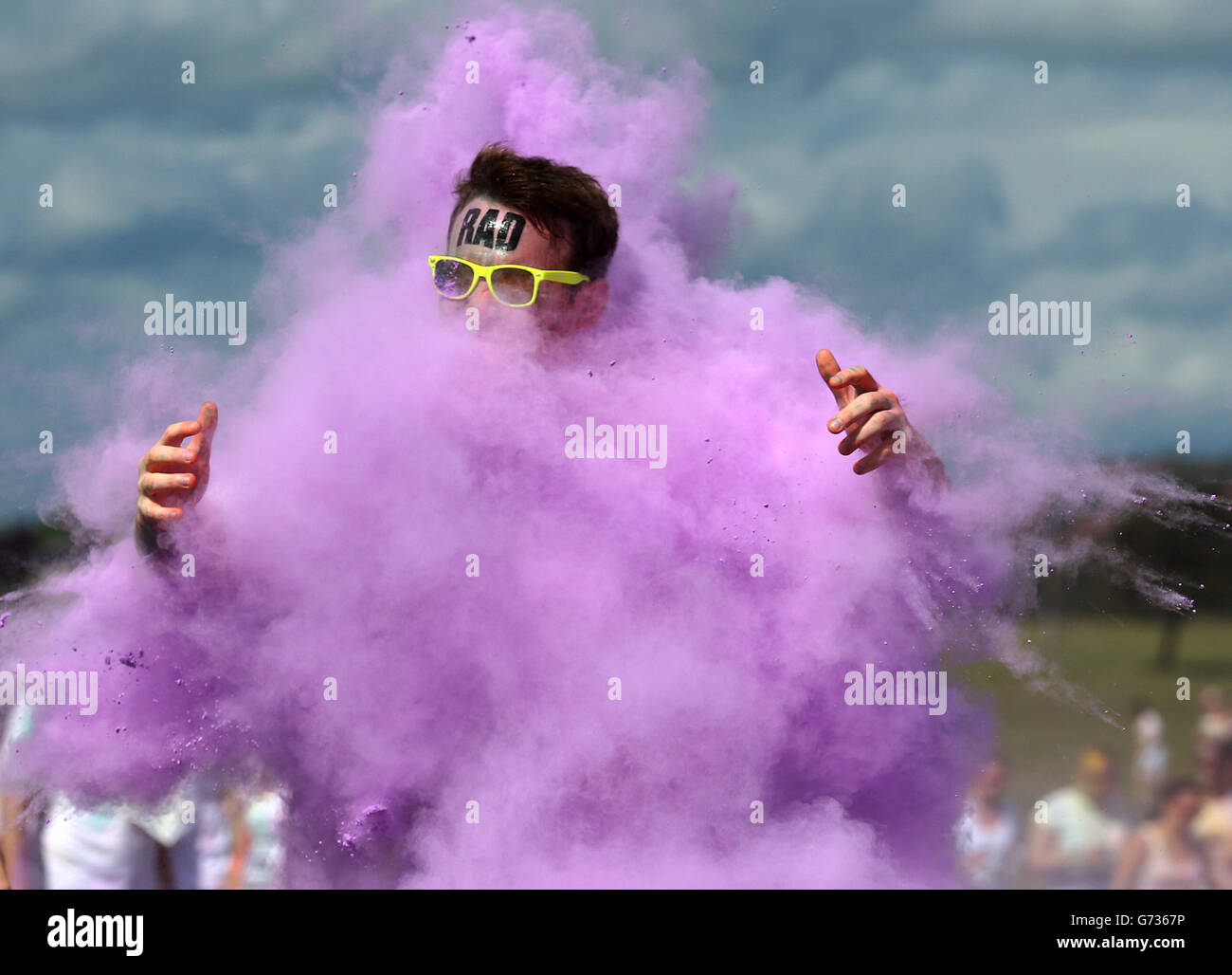 Participants take part in the Color Me Rad 5km run at Ingleston in Edinburgh where the runners are blasted with bombs of different colours during the race. Stock Photo