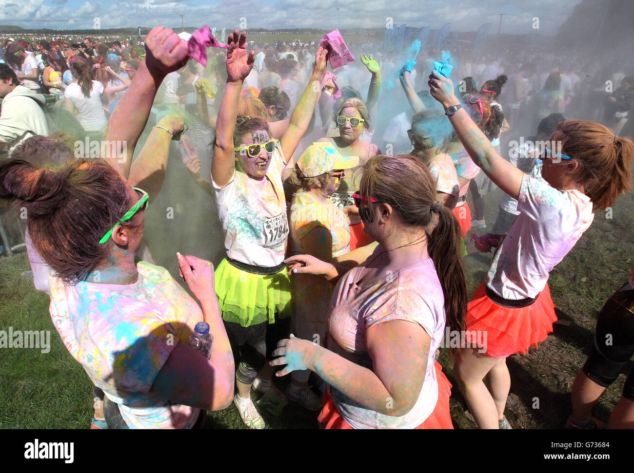 Participants take part in the Color Me Rad 5km run at Ingleston in Edinburgh where the runners are blasted with bombs of different colours during the race. Stock Photo