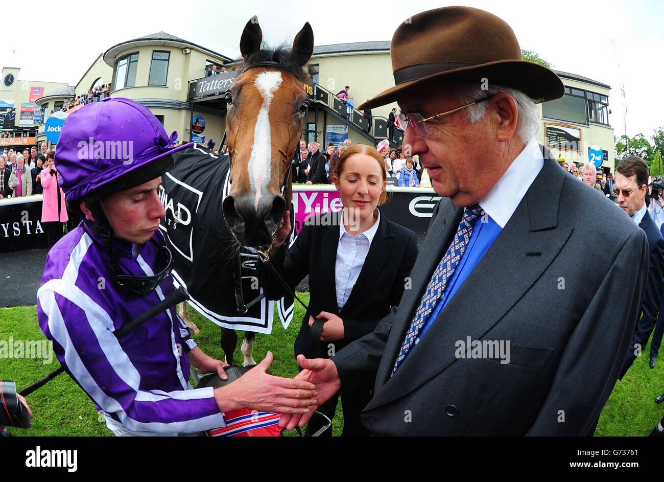 Marvellous and jockey Ryan Moore with owner John Magnier after winning The Etihad Airways Irish 1000 Guineas during the Guineas Spring Festival at The Curragh Racecourse, Co Kildare, Ireland. Stock Photo