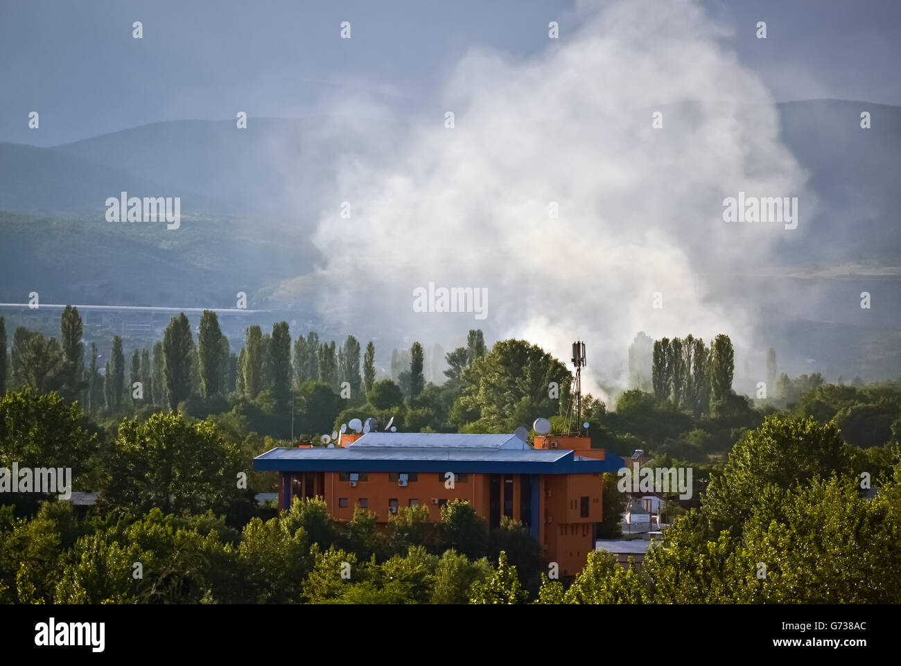 Wildfire and smoke in the forest near the building Stock Photo - Alamy