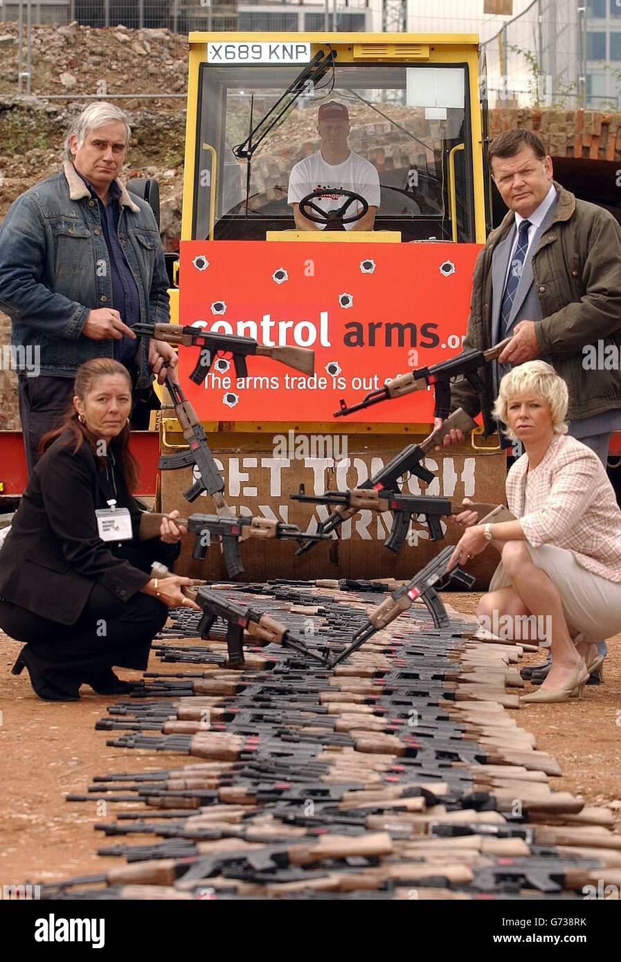 A group of four bereaved parents hold toy AK-47 machine guns, as a symbolic gesture before they are crushed in central London, to pressurise the Government to tighten controls on the arms trade. Mick North (top left) whose daughter Sophie aged 5 was killed in Dunblane in 1996, Lucy Cope (bottom left) whose son Damian aged 22 was shot dead in a London nightclub in 2002, Steve Walker (top right) whose son Andrew was shot over a disputed flat in 2001, and Jane Atkinson, whose son George aged 13 was killed by an air gun in 1999. Stock Photo