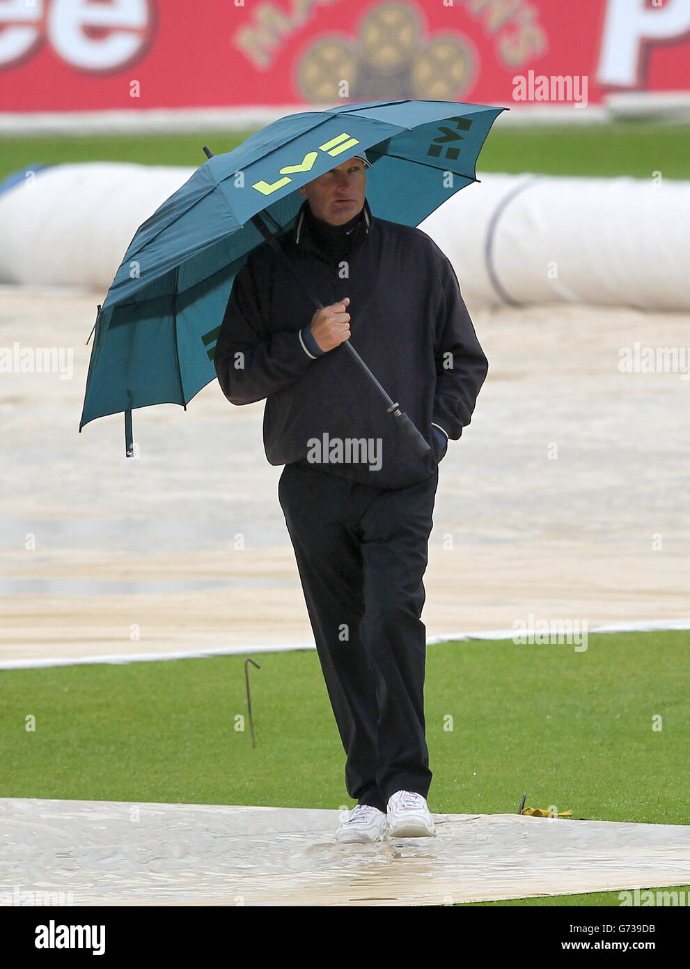 Match umpires Neil Mallender inspects the pitch with a member of the groundstaff as rain delays the start of day four during the LV=County Championship Division One match at Trent Bridge, Nottingham. Stock Photo