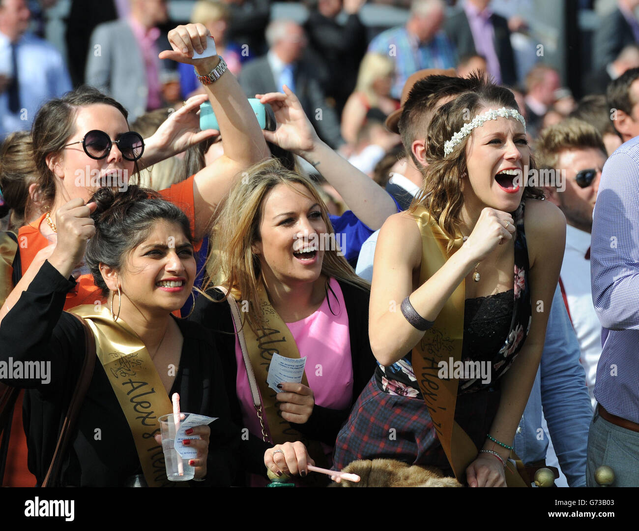 Horse Racing - Sandy Lane Stakes - Haydock Park Racecourse. Racegoers cheer on the action during the Sandy Lane Stakes day at Haydock Park Racecourse. Stock Photo