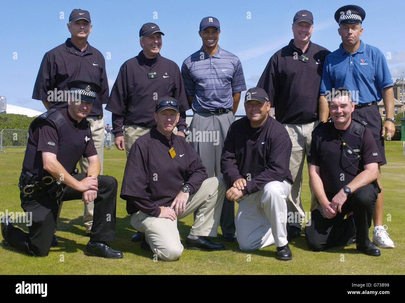 USA's Tiger Woods (centre) and caddie Steve Williams (Back right) with his security team (l-r back row) Martin Lambert-Garwyn, Michael Gallagher, Ian Price, (l-r front row) Malcolm Cochrane, Andrew Price, Blue Loome, Ian Morrow, who are looking after him for the duration of the 133rd Open Championship at the Royal Troon Golf Club, Scotland. Stock Photo