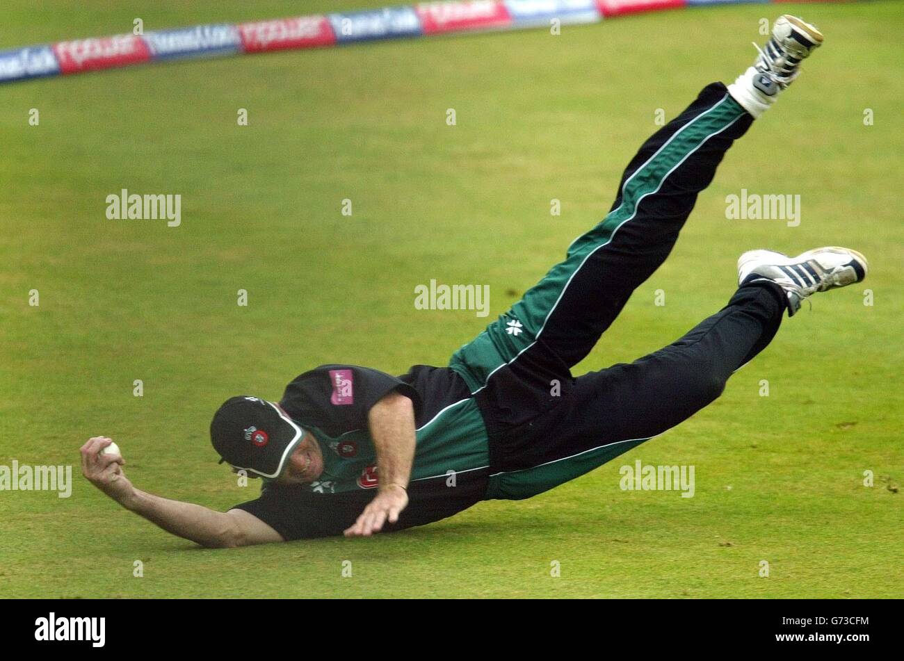 Worcestershire's Graeme Hick dives to hold on to a catch to dismiss Glamorgan's Matthew Maynard for 44 during the Twenty 20 Cup match at New Road, Worcester. Stock Photo