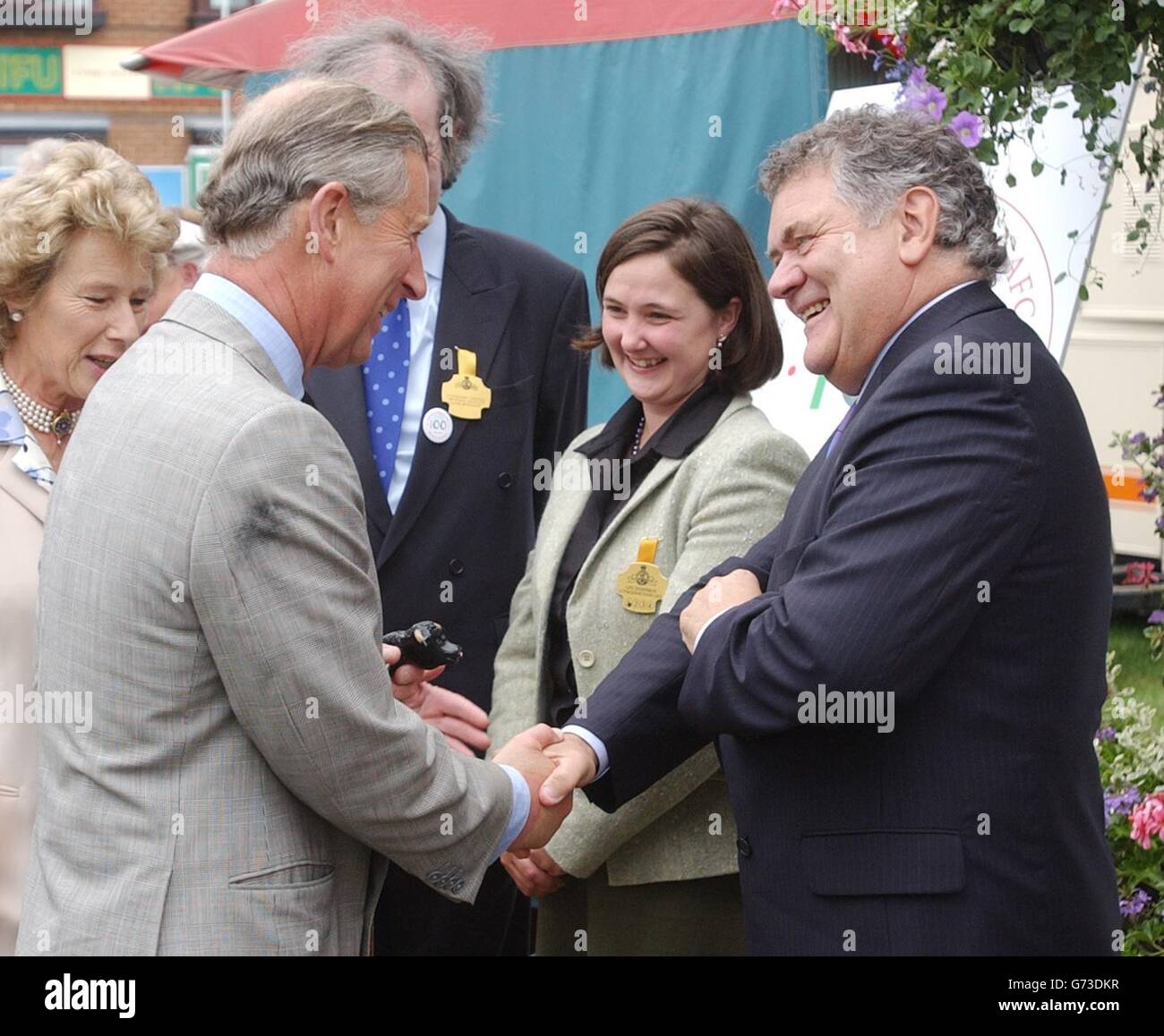 The Prince of Wales (left) meets singer and Comedian Max Boyce during his visit to the Royal Welsh Show Wales. Officially opening the event in Builth Wells, now in its centenary year, Charles said he would like to see consumers told how and where their food was grown. The Royal Welsh Show is a four-day agricultural extravaganza showcasing the best of the principality's rich rural industry. Held in July every year at its permanent show ground in Builth Wells, the event attracts more than 200,000 visitors annually. Stock Photo