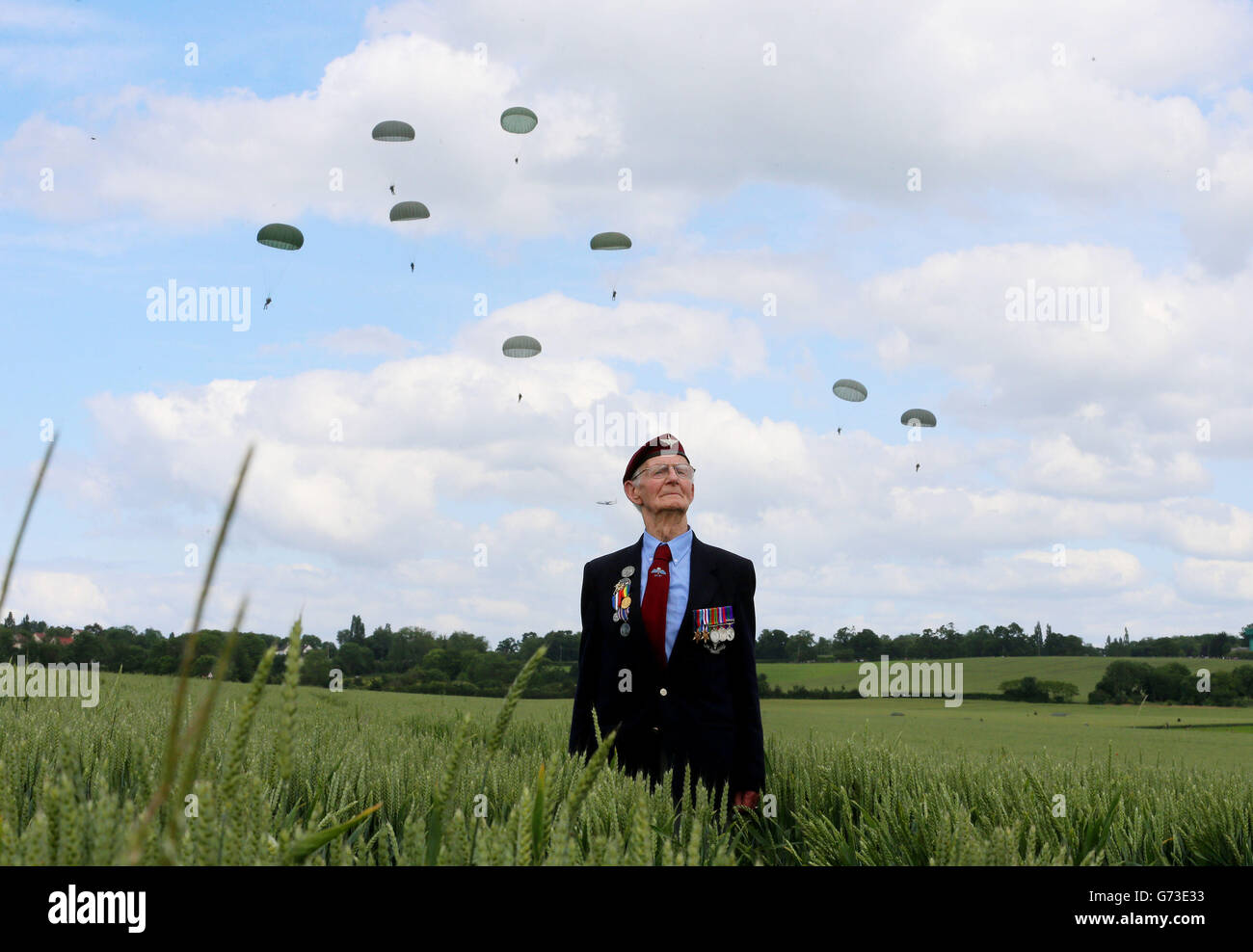 Normandy Veteran Fred Glover, 88, 9th Parachute Battalion, watches a parachute drop onto the same fields near Ranville, France that were used as a drop zone 70 years ago today to commemorate the involvement of airborne forces in D-Day. Stock Photo