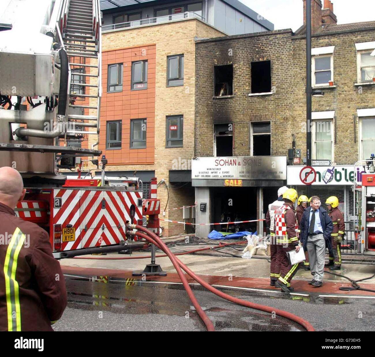 The scene in Bethnal Green, east London where two firefighters died battling a blaze in a three-storey building. It is understood that the pair were on the top floor of the building, which had a shop on the ground floor and flats above, when it appeared that the floor beneath them gave way. They were seriously injured and rushed to hospital, where they both subsequently died. Stock Photo