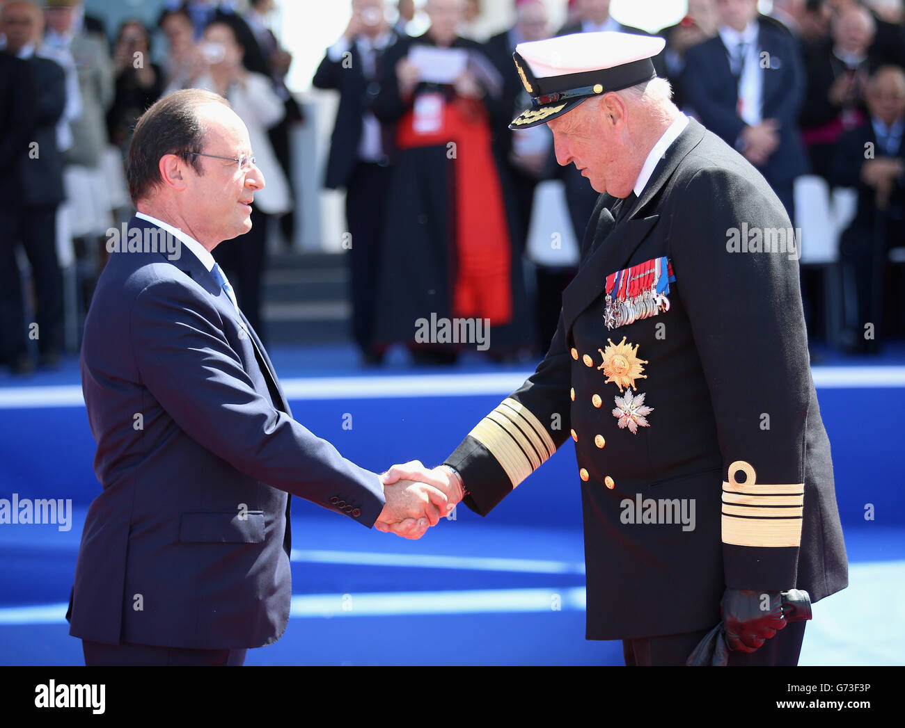 King Harald of Norway greets Francois Hollande (left) during an International Ceremony with