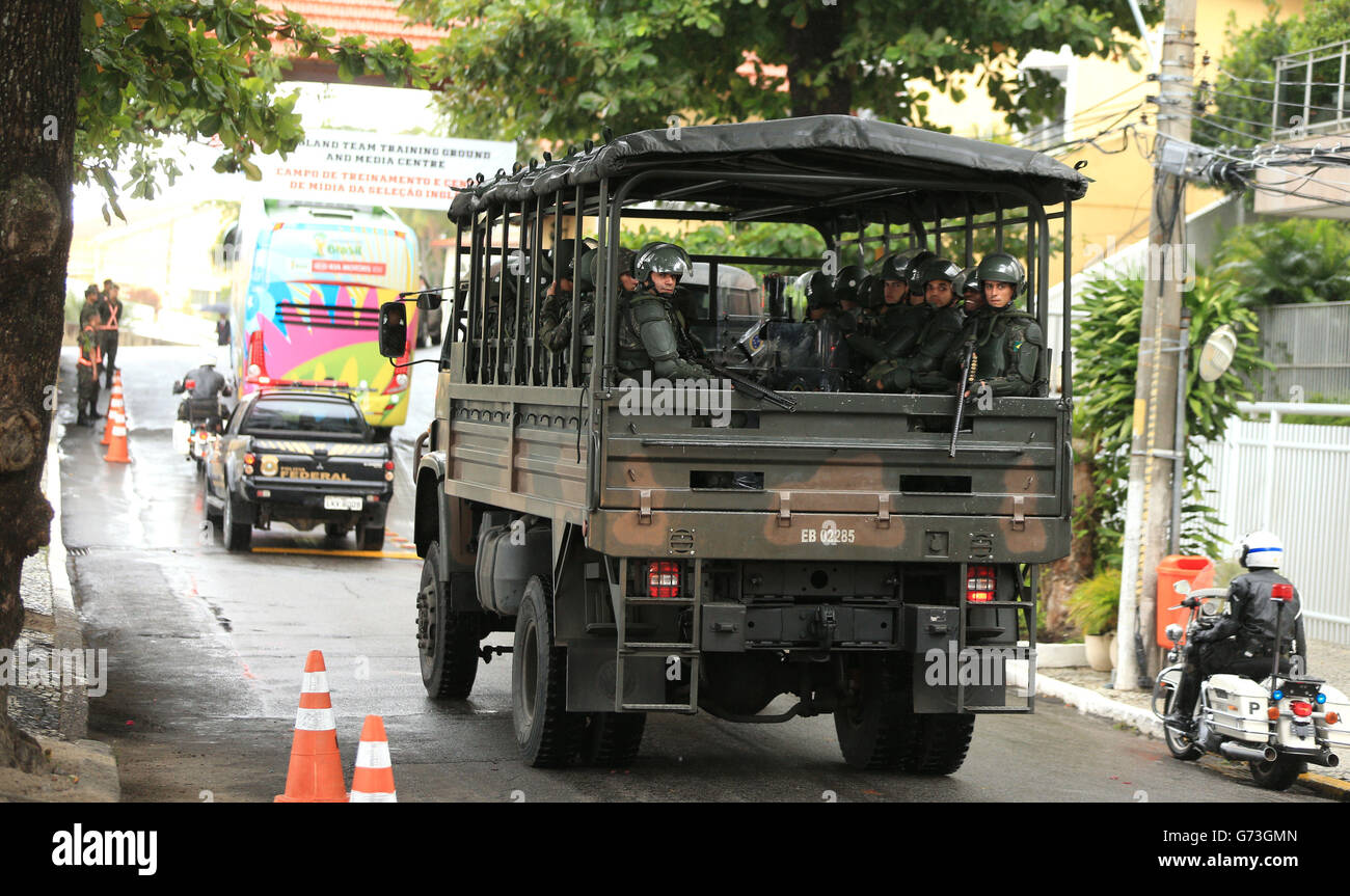 Soccer - FIFA World Cup 2014 - Group D - England v Italy - England Training Session and Press Conference - Day Two - Urca Mil.... Armed Soldiers follow the England team bus as it arrives at Urca Military Training Ground, Rio de Janeiro, Brazil. Stock Photo