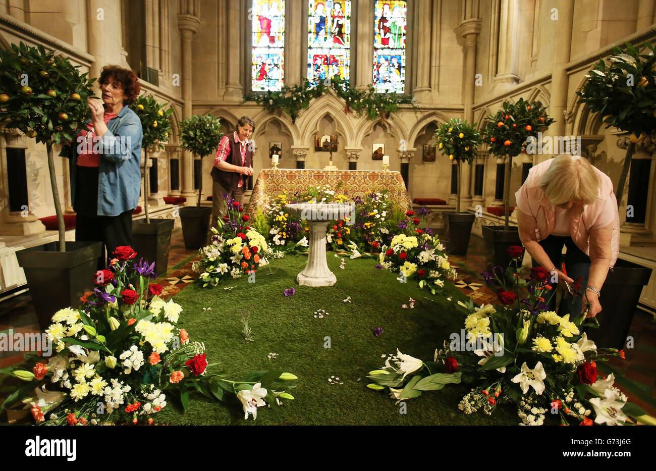 Members of the Friends of Christ Church Cathedral (left to right) Beatrice Stewart, Helen Purser, and Ruth Stewart, make final preparations ahead of The Dublin Garden Festival which takes place at the Cathedral. Stock Photo
