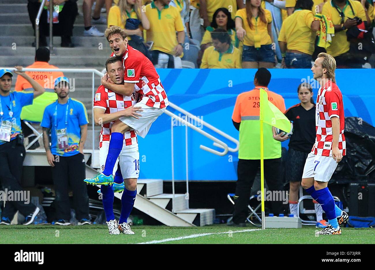 Croatia's Nikica Jelavic (centre) celebrates with Ivica Olic (left) and Ivan Rakitic after his shot is turned in by Brazil's Marcelo to give them the first goal Stock Photo