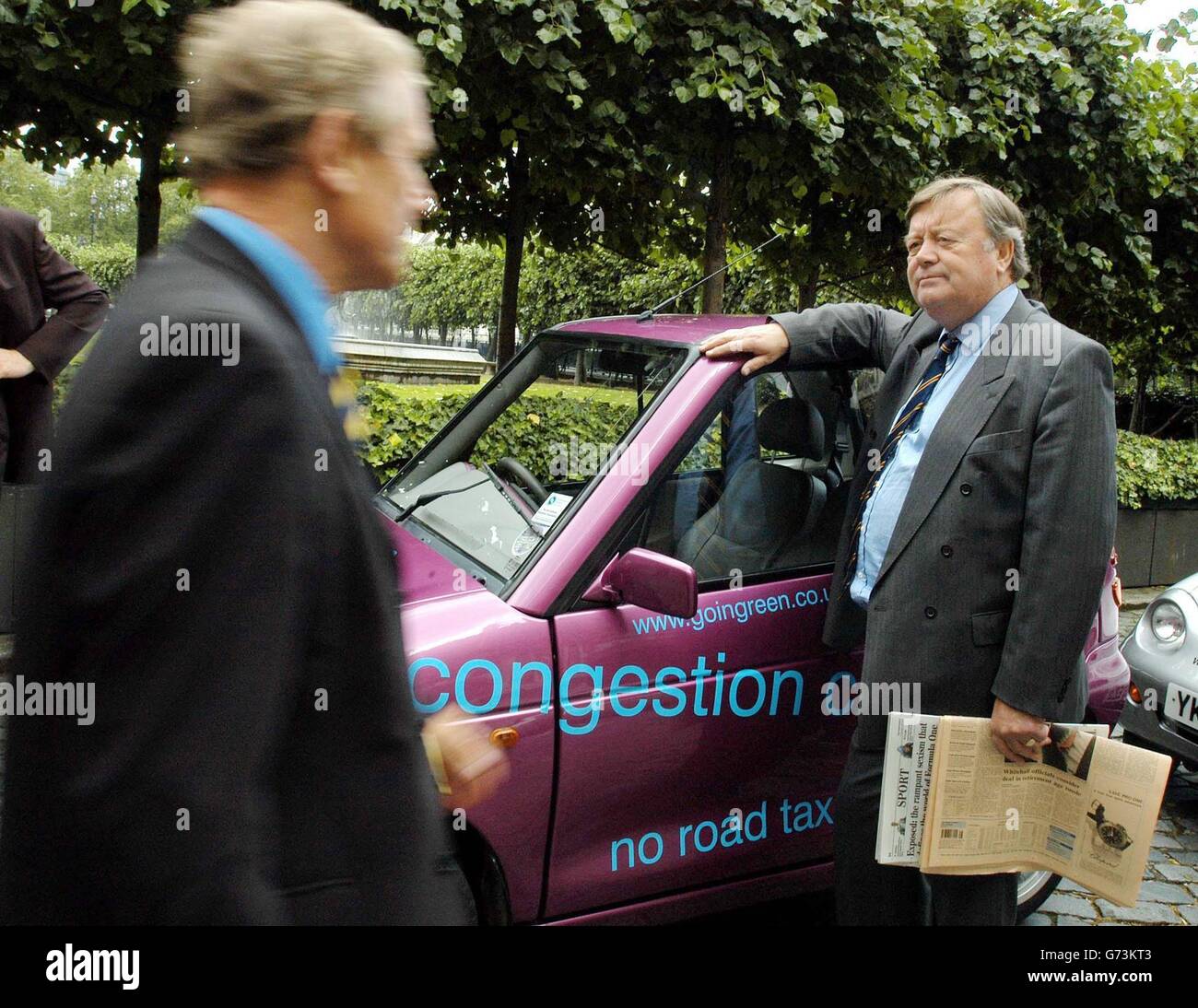 Conservative MP Kenneth Clark takes a look at the G-Wiz electric car being demonstrated outside the House of Commons in London. The makers of the G-Wiz, which costs 7599, claim it is 100% emission free, consumes just one quarter the energy of the average petrol car and is the most energy efficient car on the road according to the Energy Saving Trust. Drivers of the G-Wiz will also be exempt from the congestion charge in central London. Stock Photo