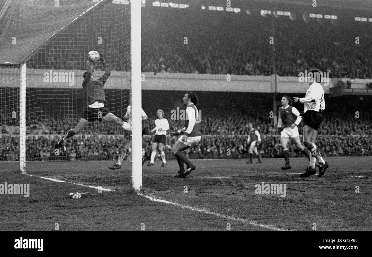 Liverpool goalkeeper Ray Clemence flies high to save a header from Arsenal No 10 Ray Kennedy (centre) in the First Division match - a goalless draw - at Highbury. Stock Photo