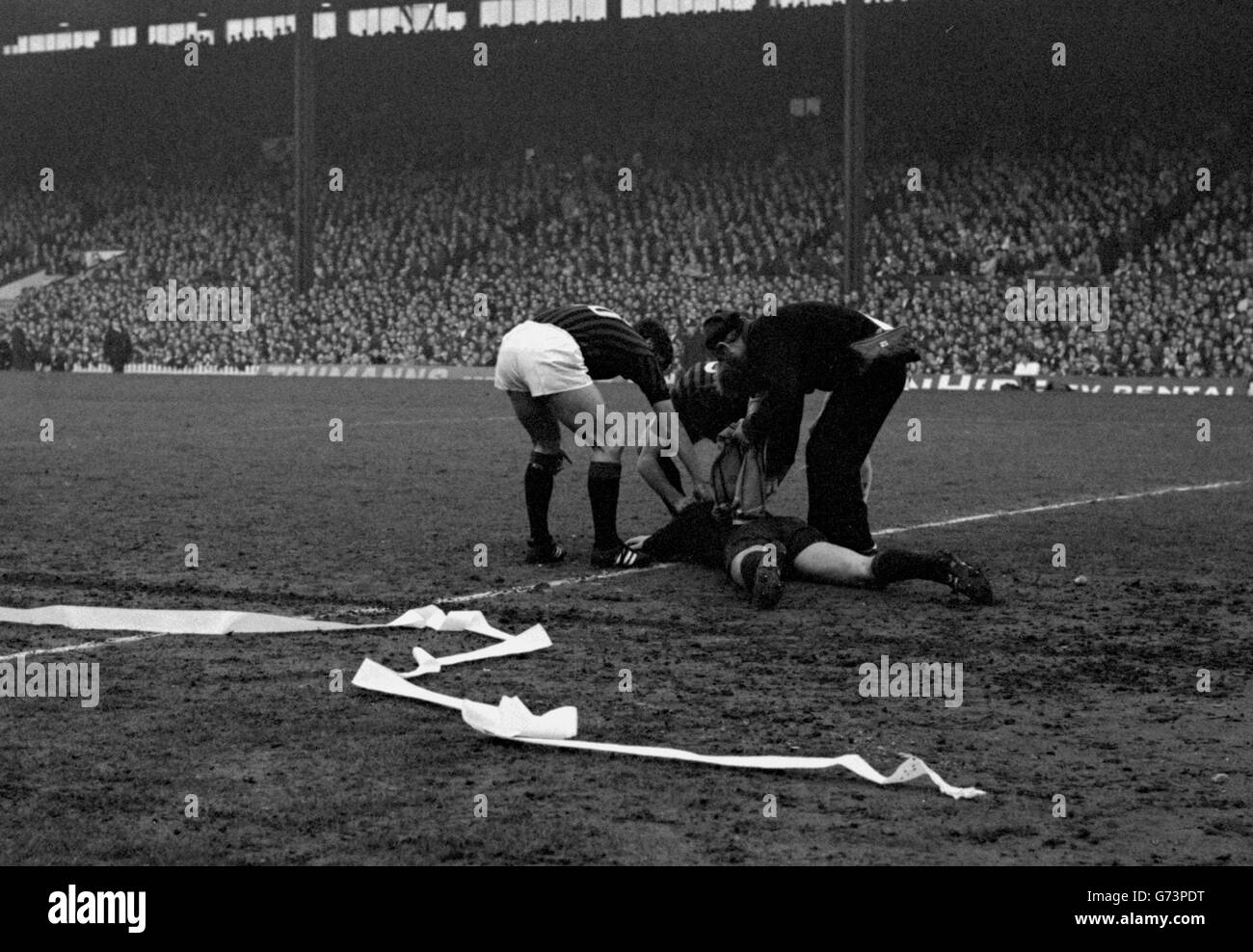 The AC Milan goalkeeper Curicini being treated by the trainer and other players after he had been knocked unconscious by a missile in the European Cup semi-final (second leg) against Manchester United at Old Trafford. Stock Photo