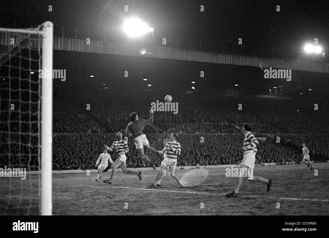 Williams, Celtic goalkeeper, punches clear from the lurking menace of Leeds leader Jones (hidden behind McNeill, right) in the European Cup semi-final, first leg at Elland Road, Leeds. At left is Celtic's Gemmell. Celtic won 1-0. Stock Photo