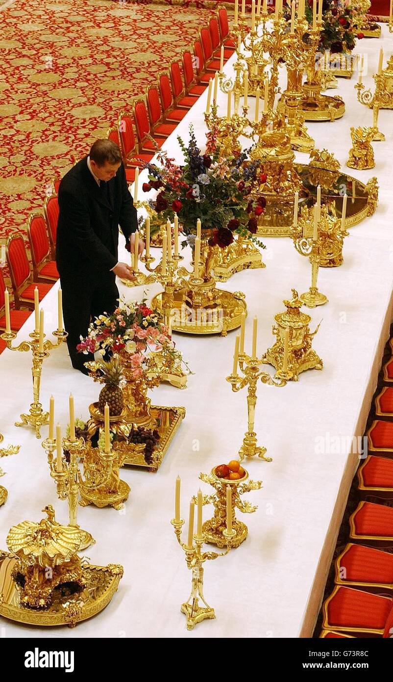 Robert Wilson, Senior Underbutler to the Silver Pantry, makes some last minute adjustments to one of the smaller candelabra of the Grand Service, the centrepiece of the Royal collection at Windsor Castle, which went display to the public for the first time. The service was used for the Grand banquet given by Queen Victoria to Tsar Nicholas I of Russia, when he visited England in June 1844. The 50 foot banquet table is situated in the Waterloo Chamber of Windsor Castle, where the large crowds of visitors will see the impessive dinning display. Stock Photo
