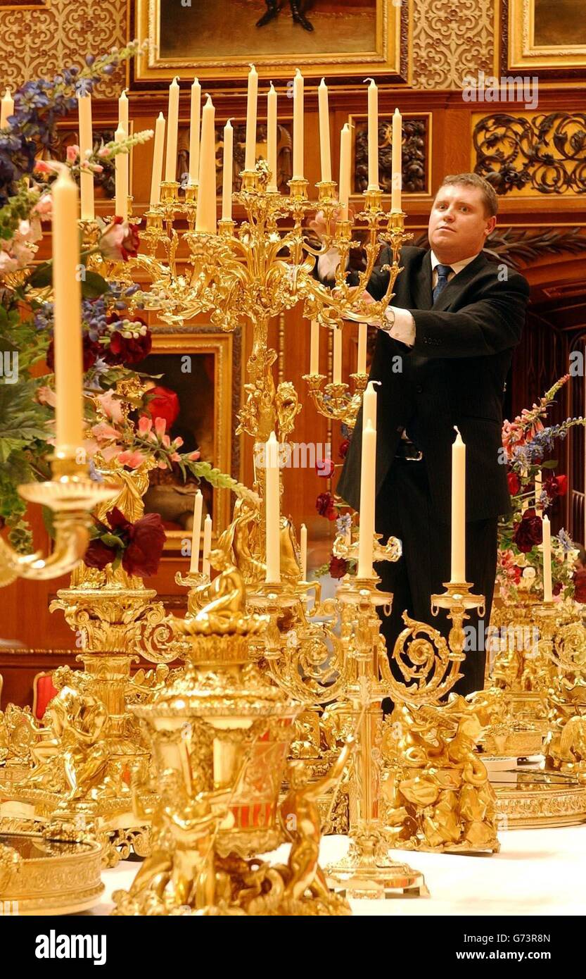 Robert Wilson, Senior Underbutler to the Silver Pantry, makes some last minute adjustments to the six-foot high candelabrum of the Grand Service, the centrepiece of the Royal collection at Windsor Castle, which went display to the public for the first time. The service was used for the Grand banquet given by Queen Victoria to Tsar Nicholas I of Russia, when he visited England in June 1844. The 50 foot banquet table is situated in the Waterloo Chamber of Windsor Castle, where the large crowds of visitors will see the impessive dinning display. Stock Photo