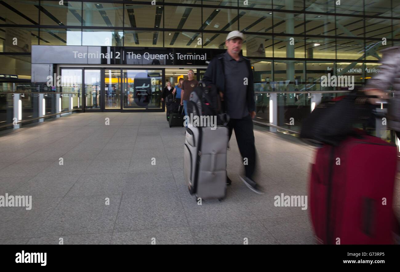 Passengers arrive at the new Terminal 2, the Queen's Terminal at Heathrow on it's first day of operation. Stock Photo