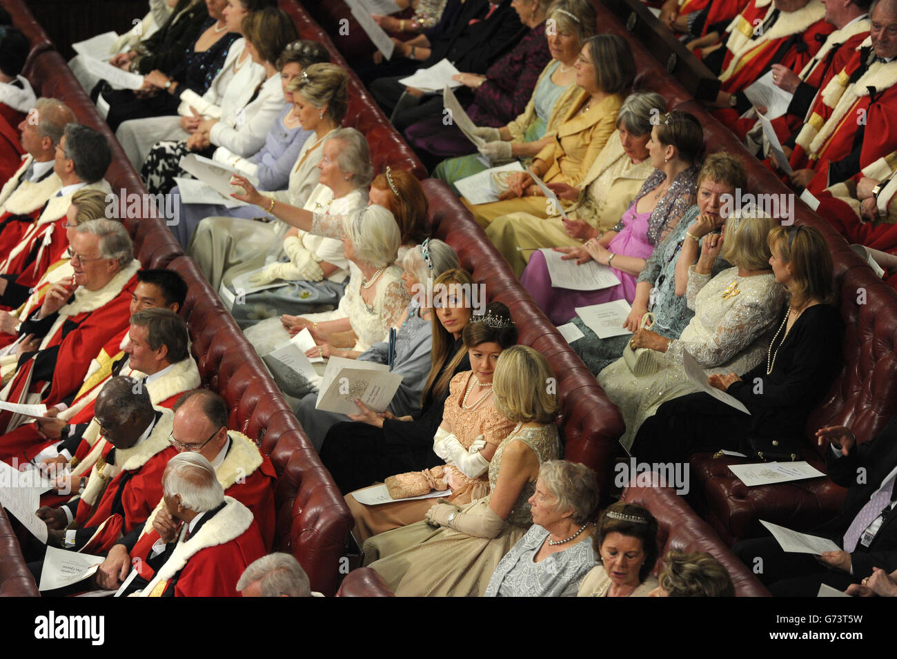 Peers and guests sit in the House of the Lords as Queen Elizabeth II