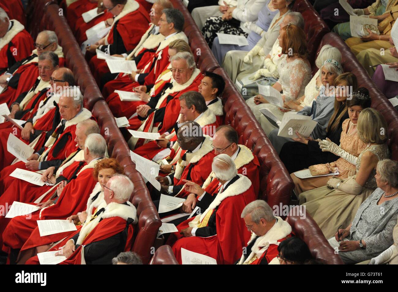 Peers and guests sit in the House of the Lords as Queen Elizabeth II